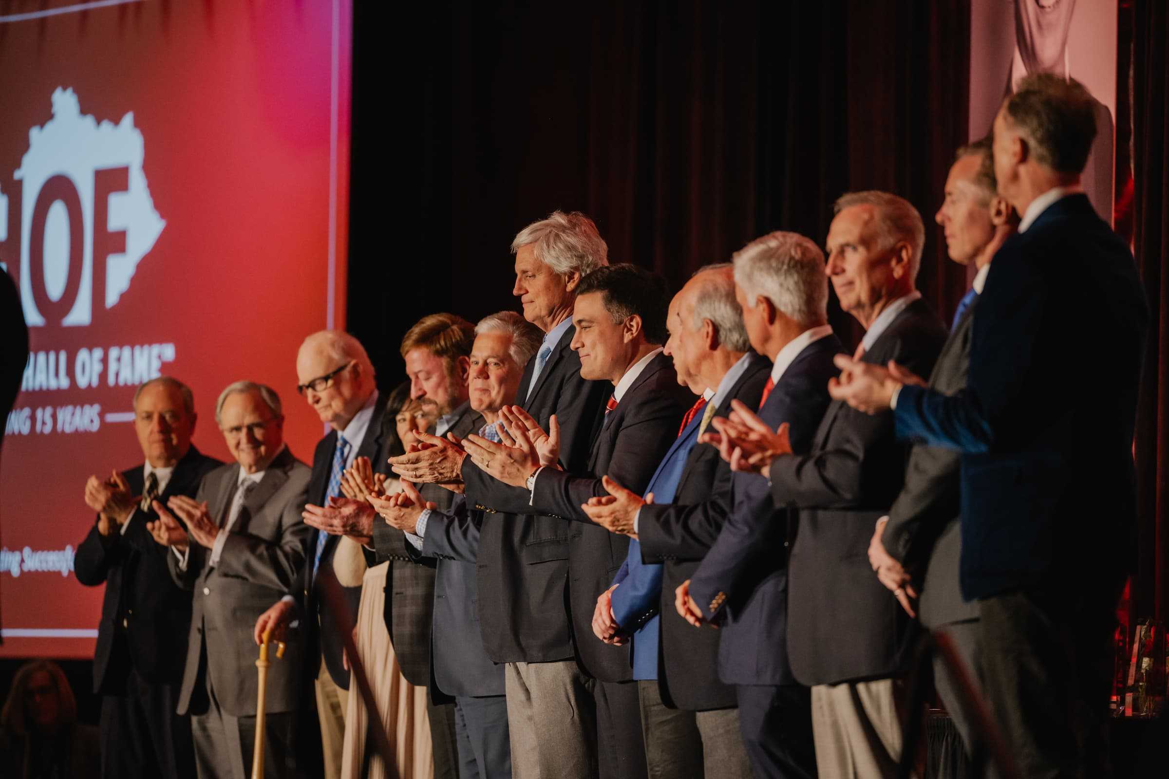 Hall of Fame inductees applauding on stage